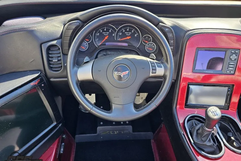 Slide: The Image of Interior of a 2010 MTI 44 Corvette, featuring steering wheel and dashboard controls. - 52