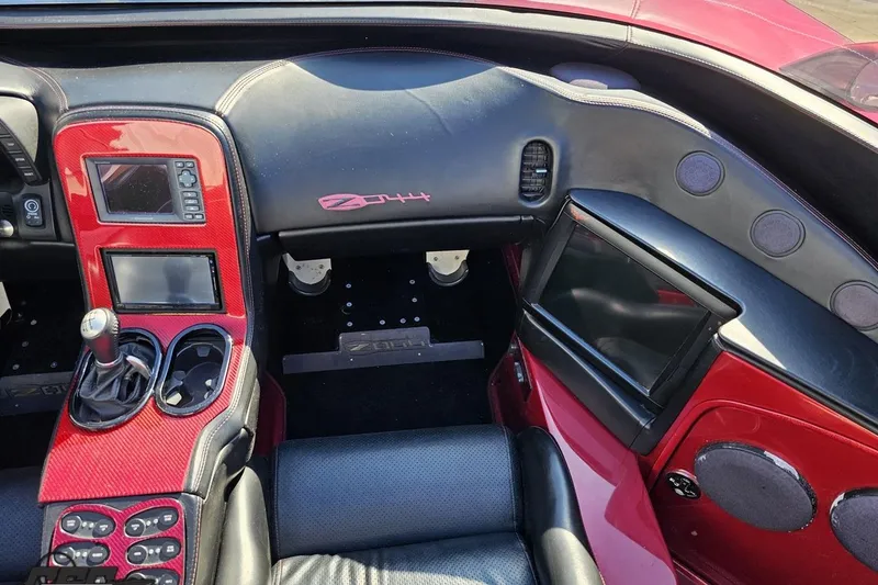 Slide: The Image of Interior of a 2010 MTI 44 Corvette, featuring red accents and modern controls. - 53