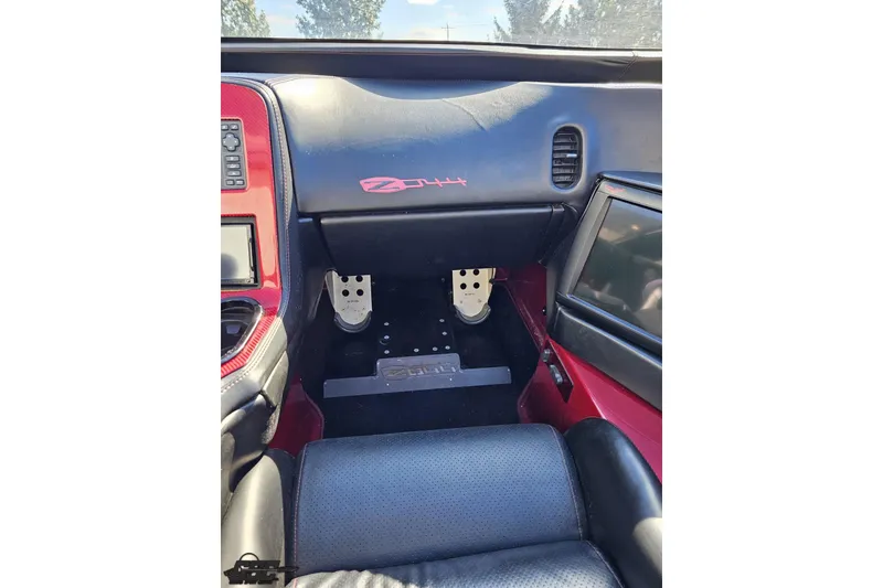 Slide: The Image of Interior of a 2010 MTI 44 Corvette, featuring custom dashboard and pedals. - 54