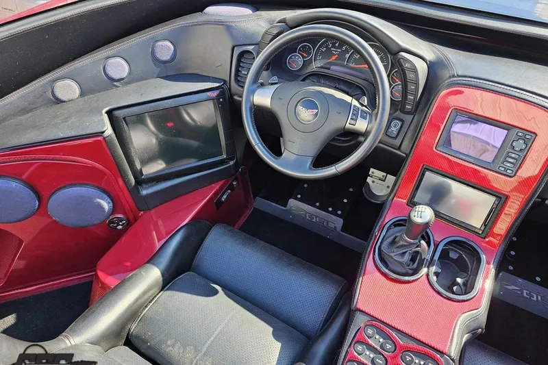 Slide: The Image of Interior of a 2010 MTI 44 Corvette, featuring a sleek dashboard and steering wheel. - 55