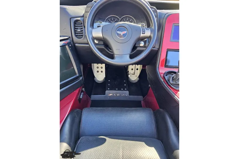 Slide: The Image of Interior view of a 2010 MTI 44 Corvette, featuring steering wheel and dashboard. - 56
