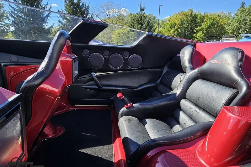 Slide: The Image of Interior of a 2010 MTI 44 Corvette, featuring black and red leather seats. - 59