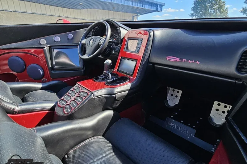 Slide: The Image of Interior of a 2010 MTI 44 Corvette, featuring custom red and black design elements. - 61