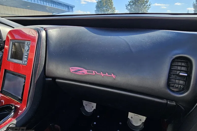 Slide: The Image of 2010 MTI 44 Corvette interior with red accents and Z44 logo on dashboard. - 62