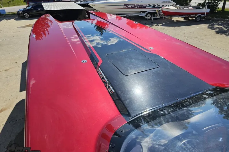 Slide: The Image of Red MTI 44 Corvette boat, 2010 model, with sleek design and reflective surface. - 65