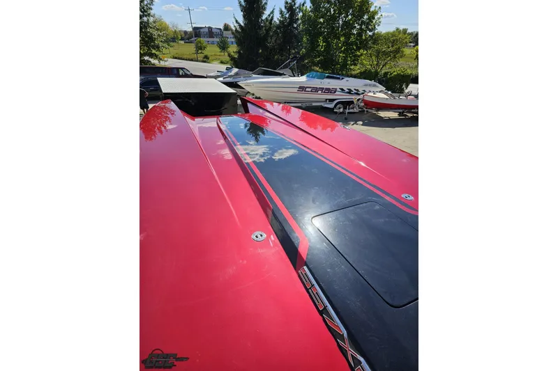 Slide: The Image of Red 2010 MTI 44 Corvette boat with sleek design, parked outdoors. - 66