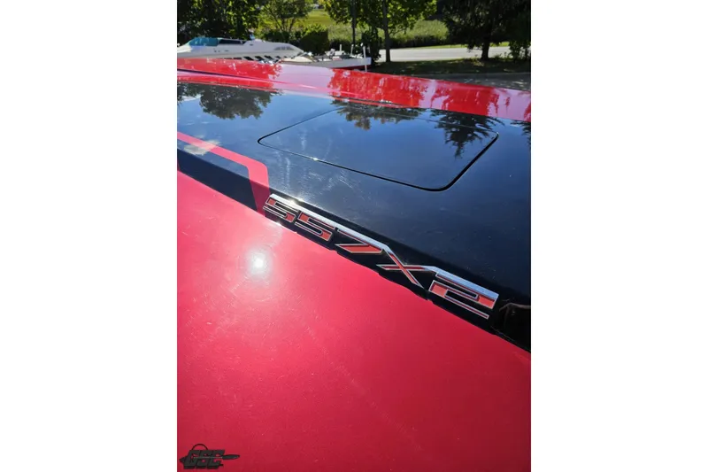 Slide: The Image of Red MTI 44 Corvette 2010 with SSX2 badge, reflecting sunlight. - 67