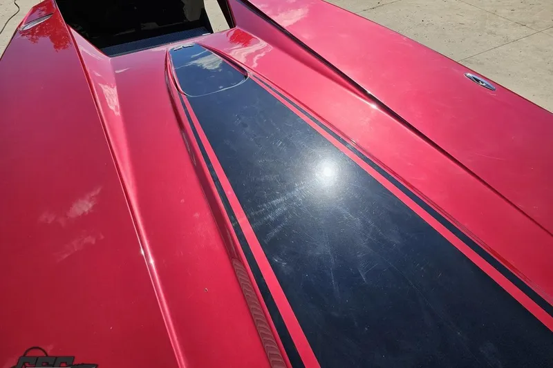 Slide: The Image of Red MTI 44 Corvette boat with black racing stripe, 2010 model, reflecting sunlight. - 68