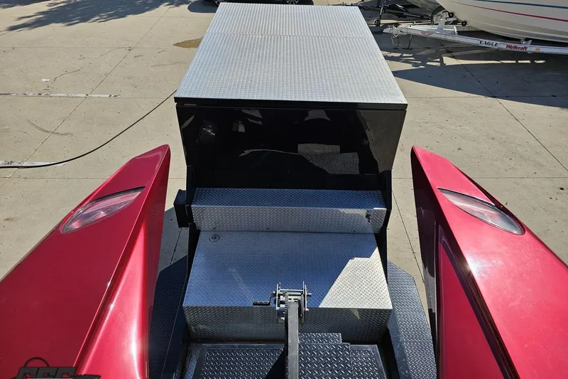 Slide: The Image of Red MTI 44 Corvette boat, 2010 model, on a trailer with diamond plate surfaces. - 70