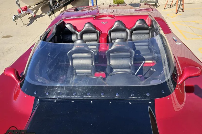 Slide: The Image of 2010 MTI 44 Corvette with sleek red and black design, featuring sporty seating. - 72