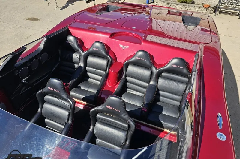 Slide: The Image of 2010 MTI 44 Corvette with red exterior and black leather seats, top view. - 73