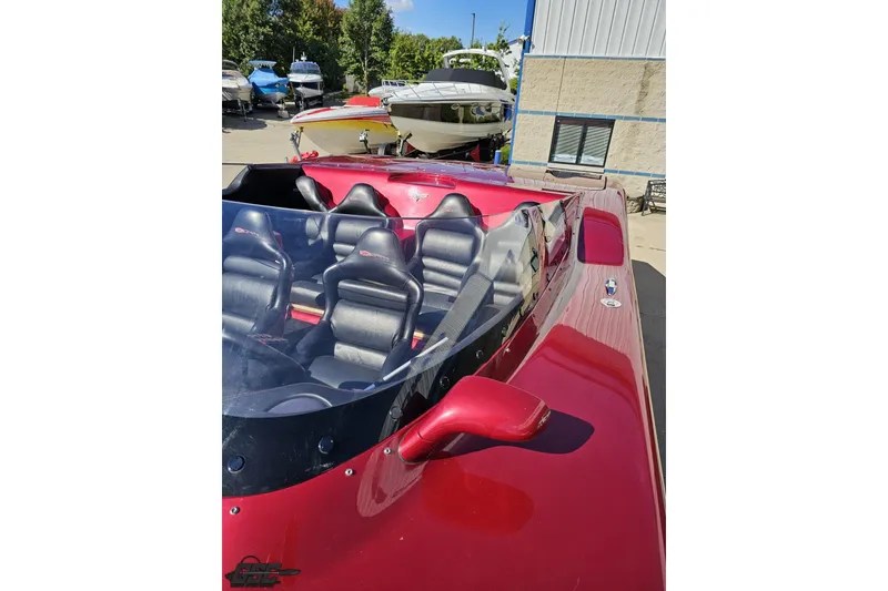 Slide: The Image of Red 2010 MTI 44 Corvette boat with sleek design and leather seats, docked outdoors. - 74