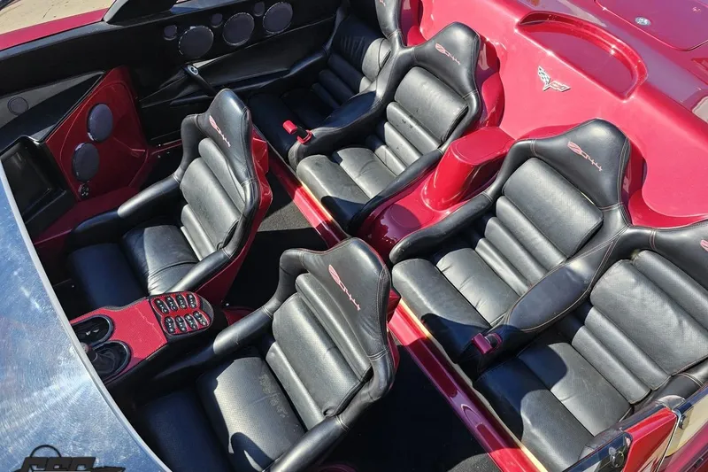 Slide: The Image of Interior of a 2010 MTI 44 Corvette with black leather seats and red accents. - 79
