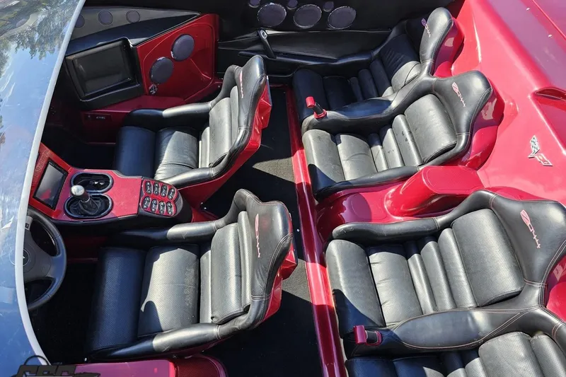 Slide: The Image of 2010 MTI 44 Corvette interior with black and red leather seats, sleek design. - 80