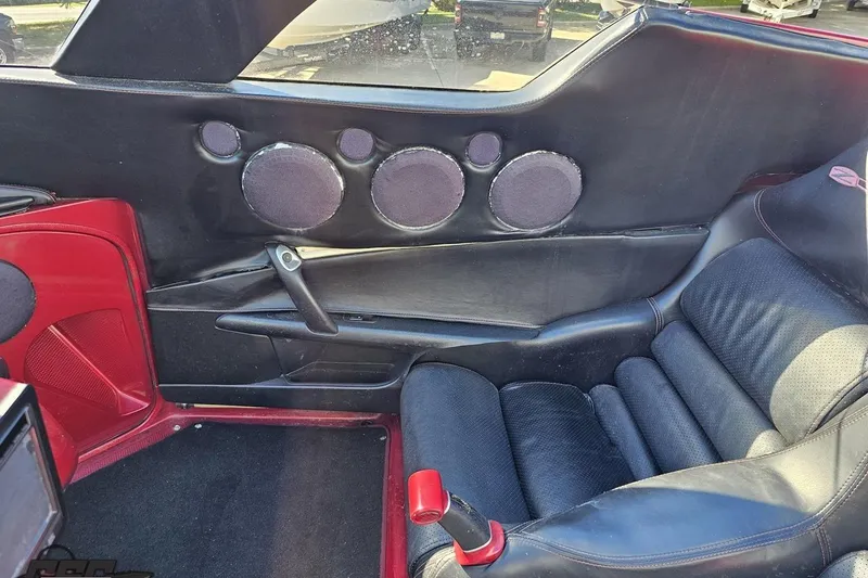 Slide: The Image of 2010 MTI 44 Corvette interior with custom black and red leather seats and speaker system. - 81