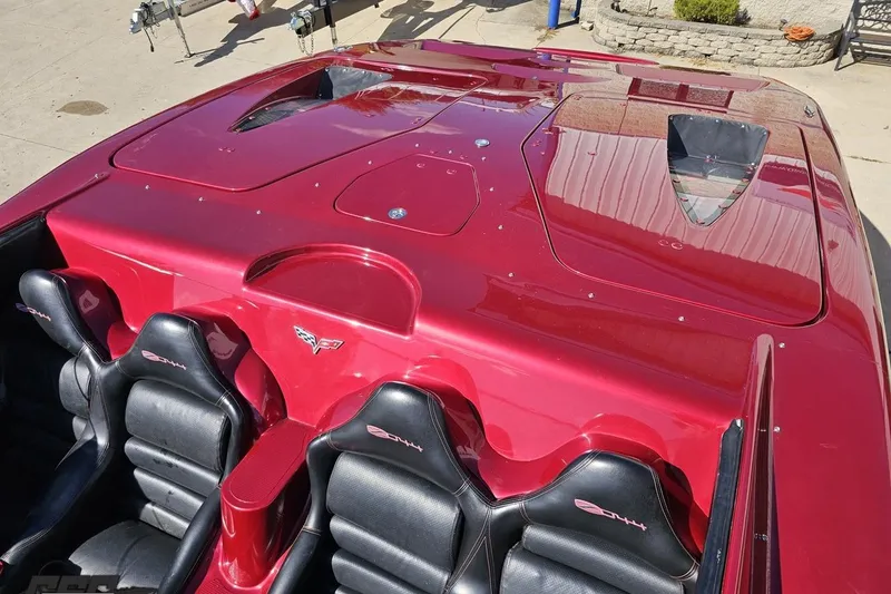 Slide: The Image of 2010 MTI 44 Corvette boat with sleek red design and black leather seats. - 82