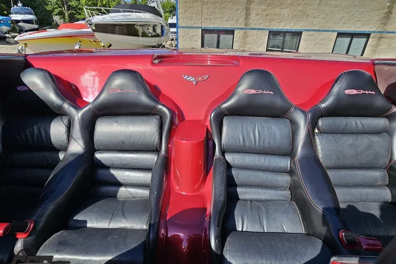 Slide: The Image of 2010 MTI 44 Corvette interior with black leather seats and red accents. - 83