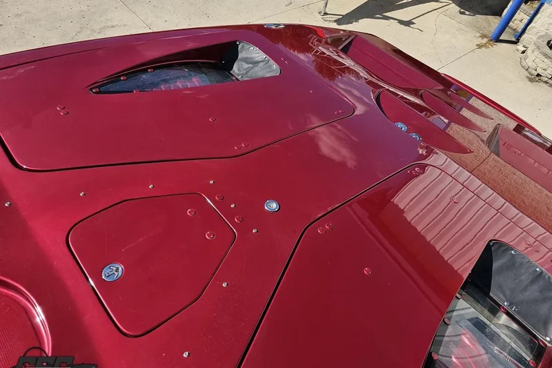 Slide: The Image of Red 2010 MTI 44 Corvette boat deck with sleek design and visible fasteners. - 87