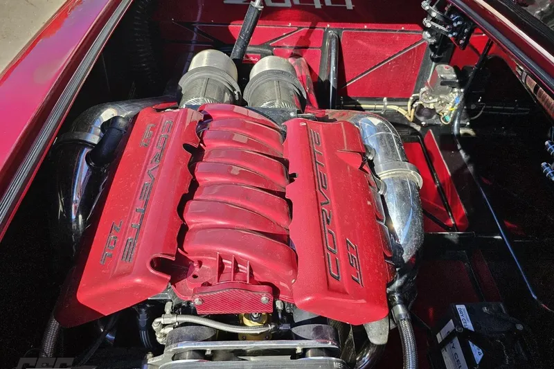 Slide: The Image of 2010 MTI 44 Corvette engine with red cover and chrome components. - 90
