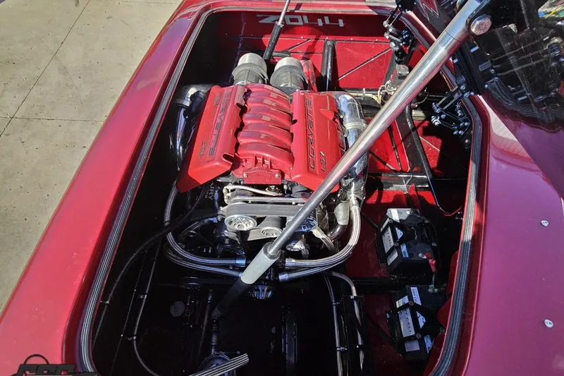 Slide: The Image of Engine compartment of a 2010 MTI 44 Corvette boat with red engine covers. - 92