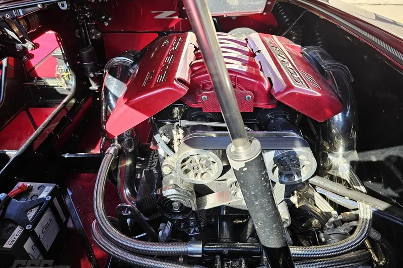 Slide: The Image of 2010 MTI 44 Corvette engine with red cover and visible components. - 97