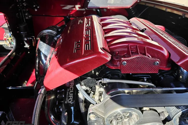 Slide: The Image of 2010 MTI 44 Corvette engine with red cover, showcasing 7.0L Mercury Racing components. - 98