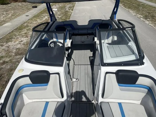 Slide: The Image of 2020 Yamaha Boats 242X interior view with seating and steering wheel. - 13