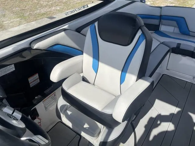 Slide: The Image of 2020 Yamaha Boats 242X captain's chair with blue and white upholstery. - 14