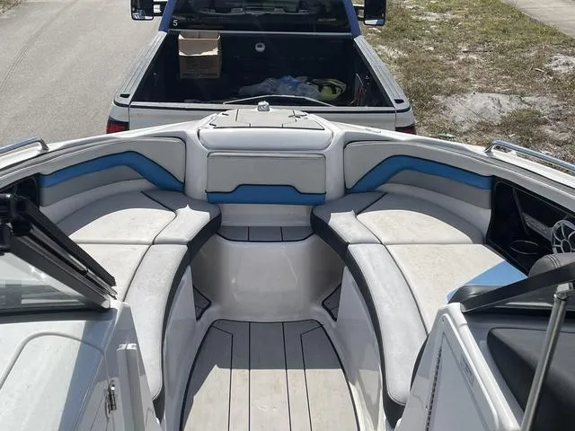 Slide: The Image of 2020 Yamaha Boats 242X interior with cushioned seating and storage compartments. - 18