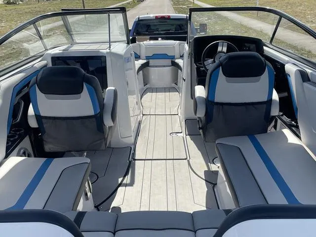 Slide: The Image of 2020 Yamaha Boats 242X interior with seating and steering console. - 20