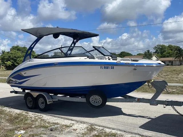 Slide: The Image of 2020 Yamaha Boats 242X on trailer, blue and white, with bimini top. - 6