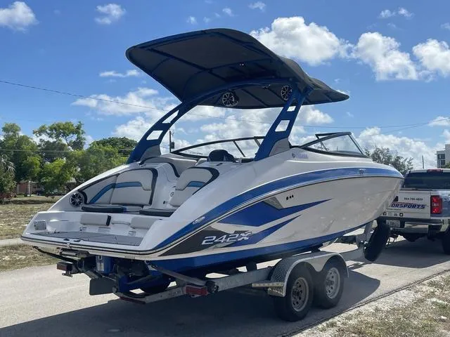 Slide: The Image of 2020 Yamaha Boats 242X on a trailer, ready for transport under a sunny sky. - 7