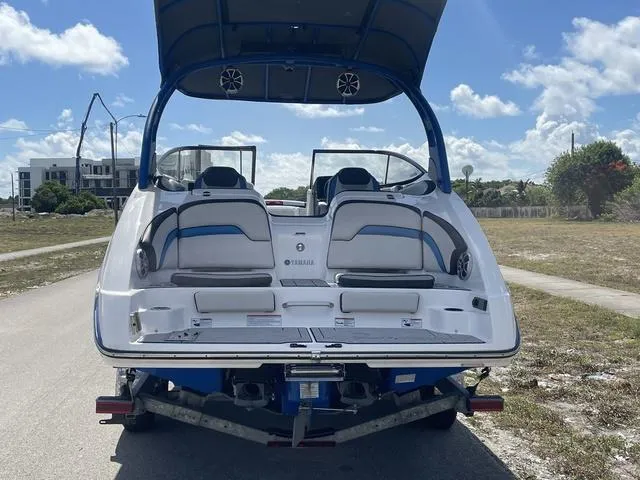 Slide: The Image of 2020 Yamaha Boats 242X on trailer, rear view with seating and speakers. - 8