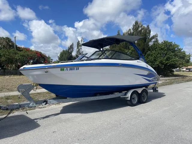 Slide: The Image of 2020 Yamaha Boats 242X on a trailer under a blue sky. - 9