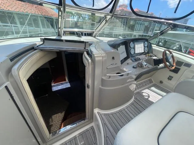 Slide: The Image of 2005 Sea Ray 390 Sundancer cockpit with helm and cabin entrance. - 13