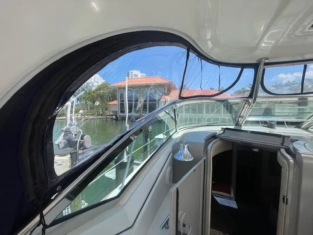 Slide: The Image of Interior view of 2005 Sea Ray 390 Sundancer yacht with marina backdrop. - 14