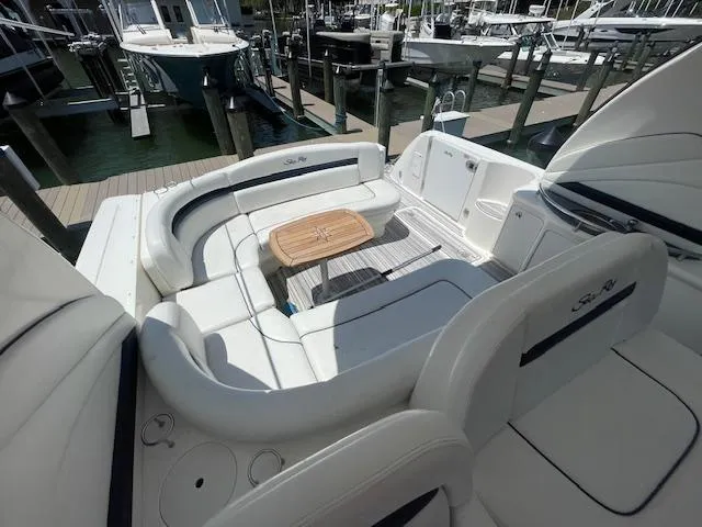 Slide: The Image of 2005 Sea Ray 390 Sundancer yacht with spacious seating area and wooden table. - 17