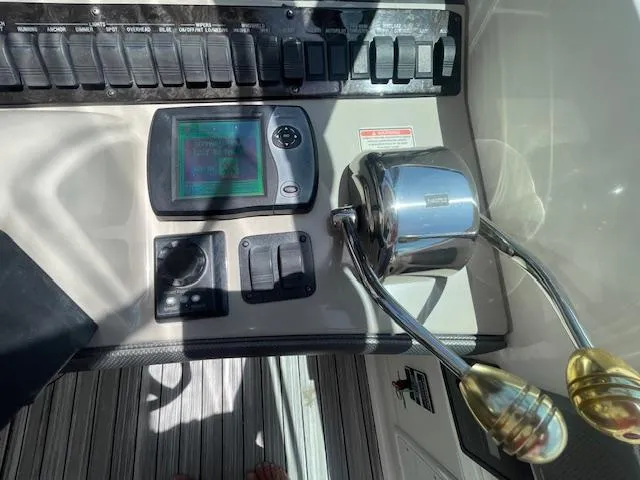 Slide: The Image of Control panel of a 2005 Sea Ray 390 Sundancer boat with throttle and navigation display. - 27
