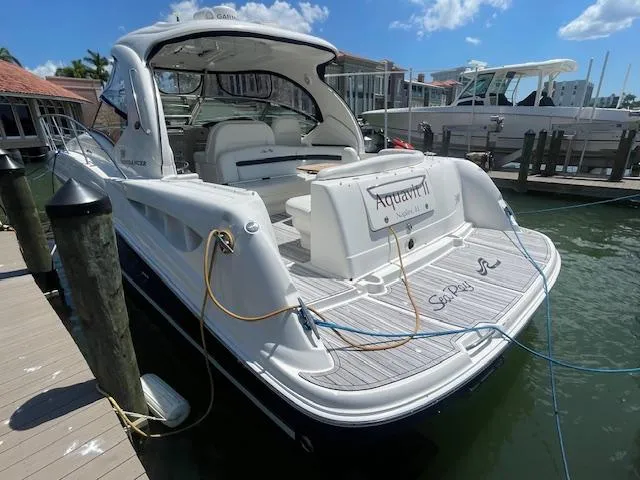 Slide: The Image of 2005 Sea Ray 390 Sundancer docked, rear view with Aquavit nameplate. - 3