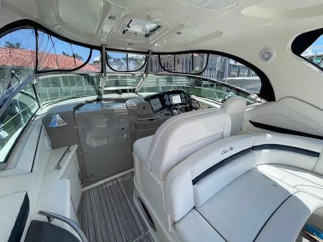 Slide: The Image of 2005 Sea Ray 390 Sundancer cockpit with helm and seating area - 30