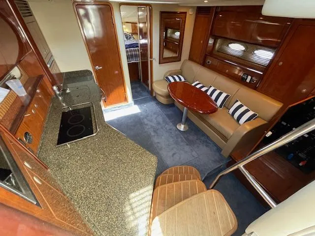Slide: The Image of Interior of 2005 Sea Ray 390 Sundancer yacht with kitchen, seating area, and bedroom. - 32