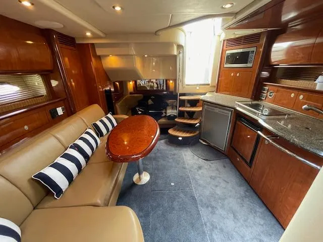 Slide: The Image of Interior of 2005 Sea Ray 390 Sundancer yacht with kitchen and seating area. - 36