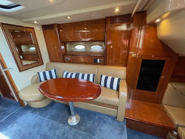 Slide: The Image of Luxurious interior of 2005 Sea Ray 390 Sundancer yacht with plush seating and wooden finishes. - 39