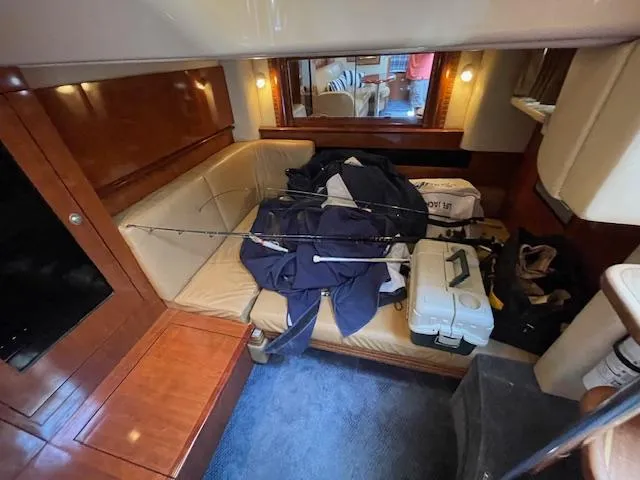 Slide: The Image of Interior cabin of 2005 Sea Ray 390 Sundancer with fishing gear and supplies. - 40