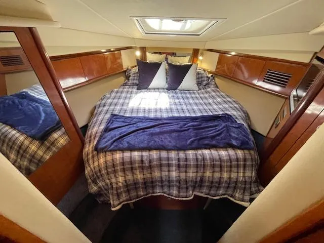 Slide: The Image of Luxurious bedroom interior of 2005 Sea Ray 390 Sundancer yacht with plaid bedding. - 41