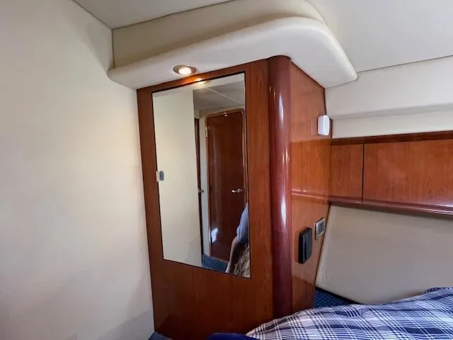 Slide: The Image of Interior cabin of 2005 Sea Ray 390 Sundancer with wood paneling and mirror. - 44