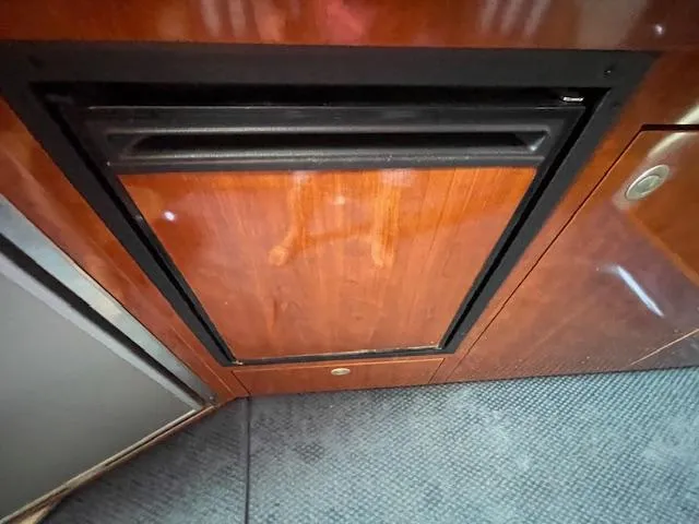 Slide: The Image of Wood-paneled refrigerator in 2005 Sea Ray 390 Sundancer yacht interior. - 49