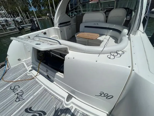 Slide: The Image of 2005 Sea Ray 390 Sundancer yacht with open storage compartment and seating area. - 6