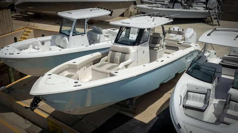 Slide: The Image of 2024 Solace 32 CS boat in a marina, showcasing sleek design and modern features. - 1