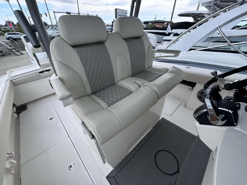 Slide: The Image of 2024 Solace 32 CS boat interior with dual captain's seats and modern helm controls. - 13